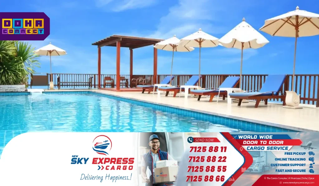 A scenic view of a luxury swimming pool in Doha with clear blue water, lounge chairs, and palm trees—ideal for family fun and fitness.